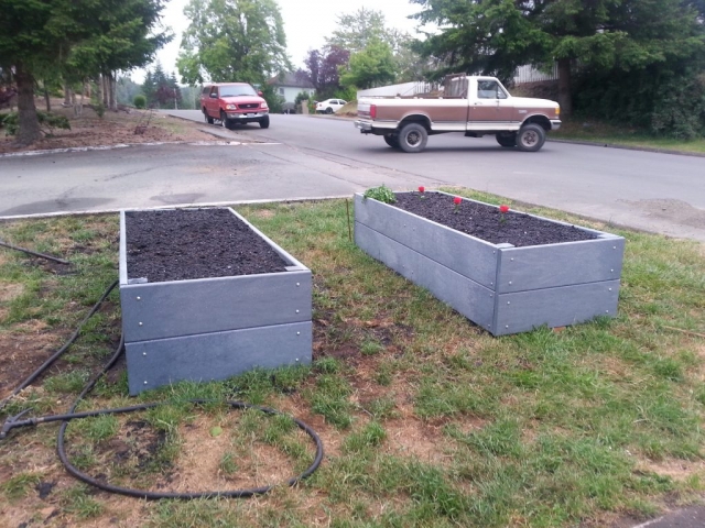 Raised garden beds built from gray MAXiTUF recycled plastic lumber